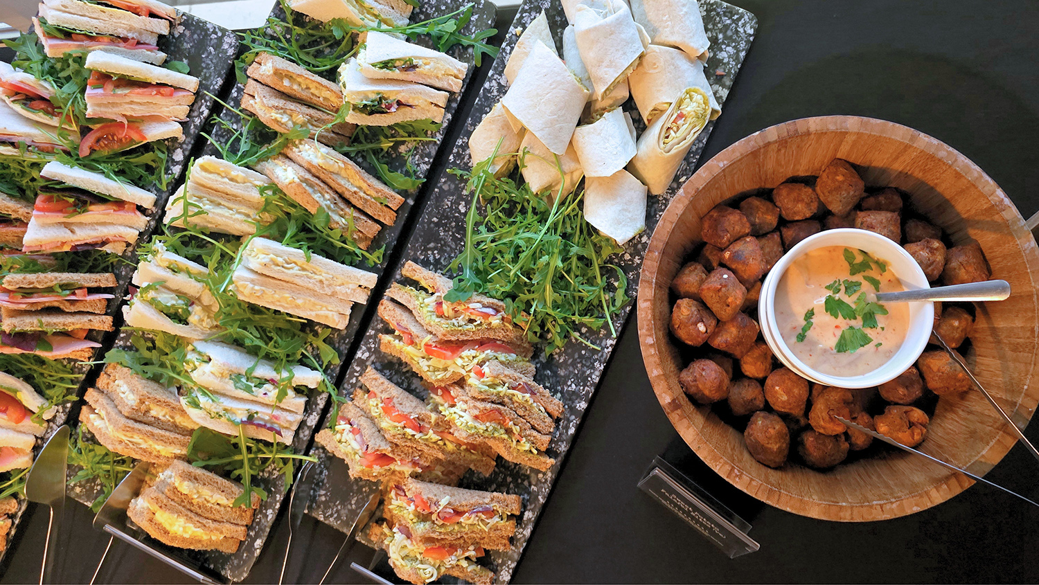 Mixed selection of sandwiches on a platter dish.