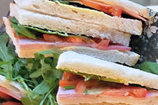Mixed selection of sandwiches on a platter dish.